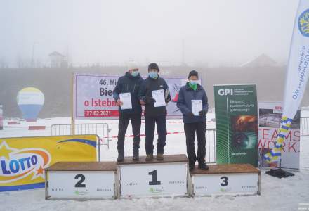 Podium Mistrzostw Polski Amatorów kategoria M70: miejsce 1.Mazurek Kazimierz, miejsce 2. Faron Piotr miejsce 3. Sikora Stefan; w tle baner imprezy i banery sponsorów